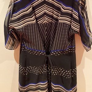 Black dress size XS with open slit on top of sleeves. Ties at the waist.